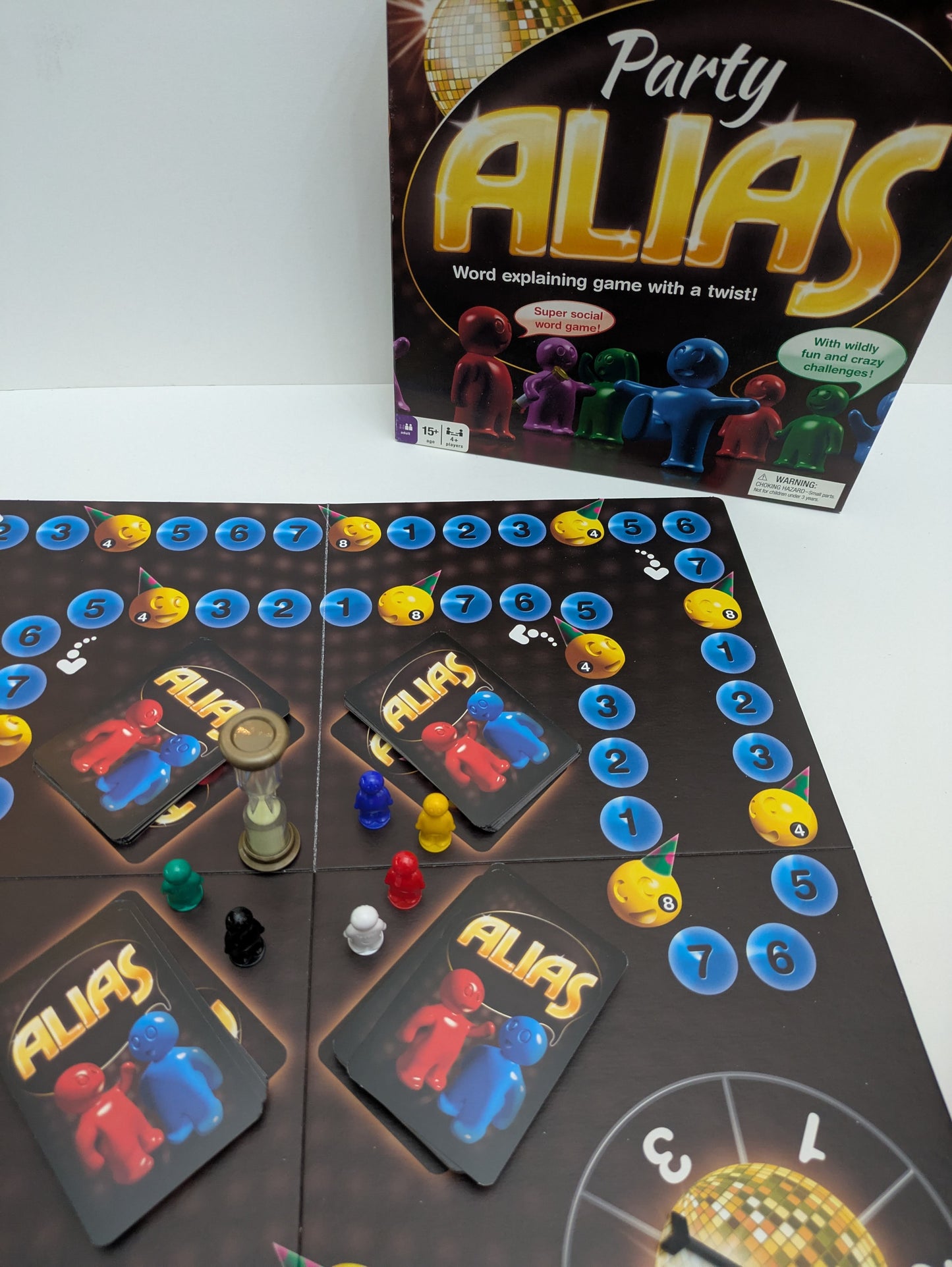 Complete Party Alias (2009) game setup with word cards, timer, and scoring pieces ready for a fun-filled word-guessing party
