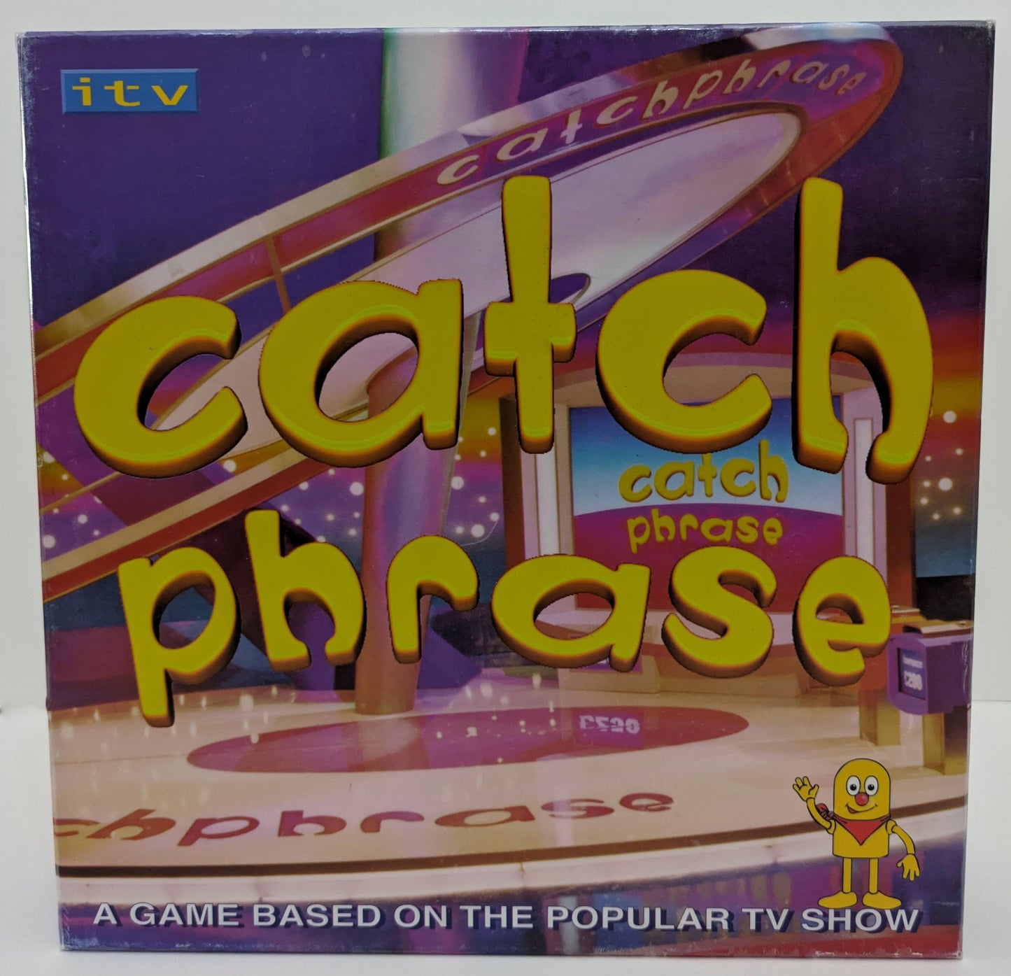 Catch Phrase Board Game (2005) box featuring TV show graphics, phrase cards, and the iconic game logo highlighting creative guessing gameplay.