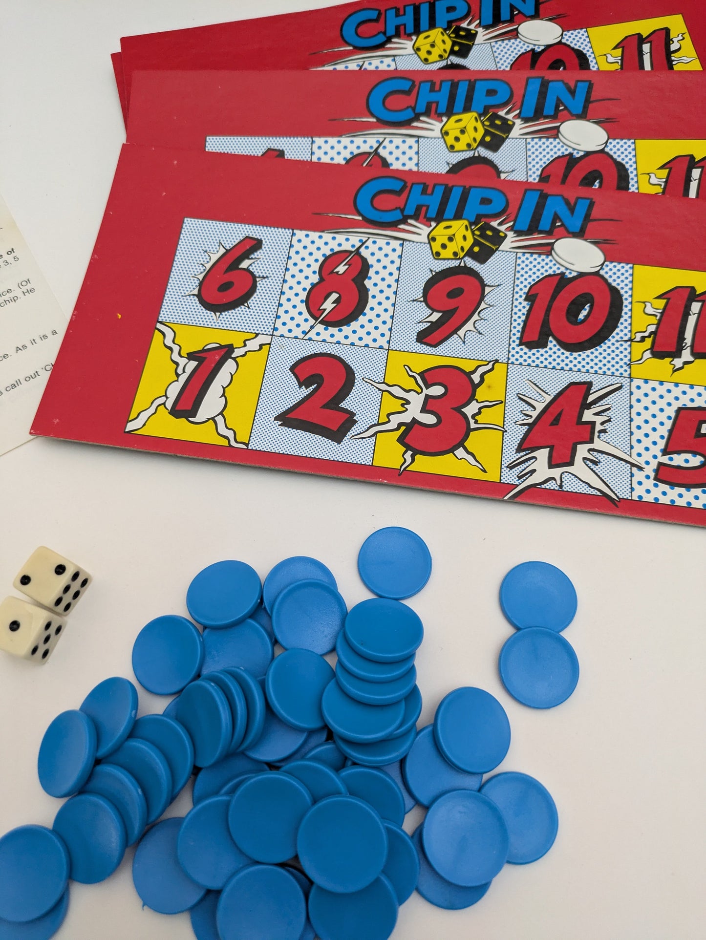 Complete Chip In (1988) setup with dice, numbered boards, and colourful chips ready for fast-paced family gameplay.