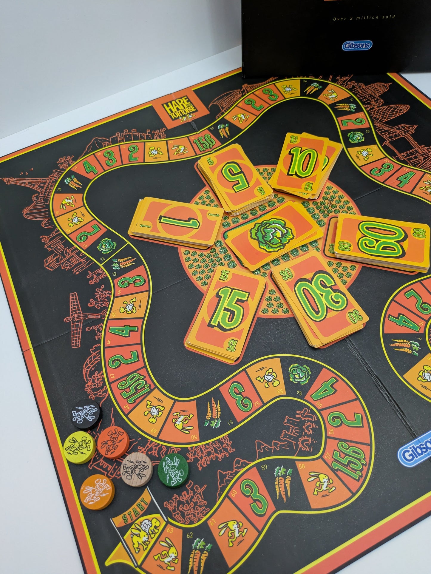 Complete setup of Hare and Tortoise game with game board, carrot tokens, lettuce cards, and player tokens ready for strategic racing fun.