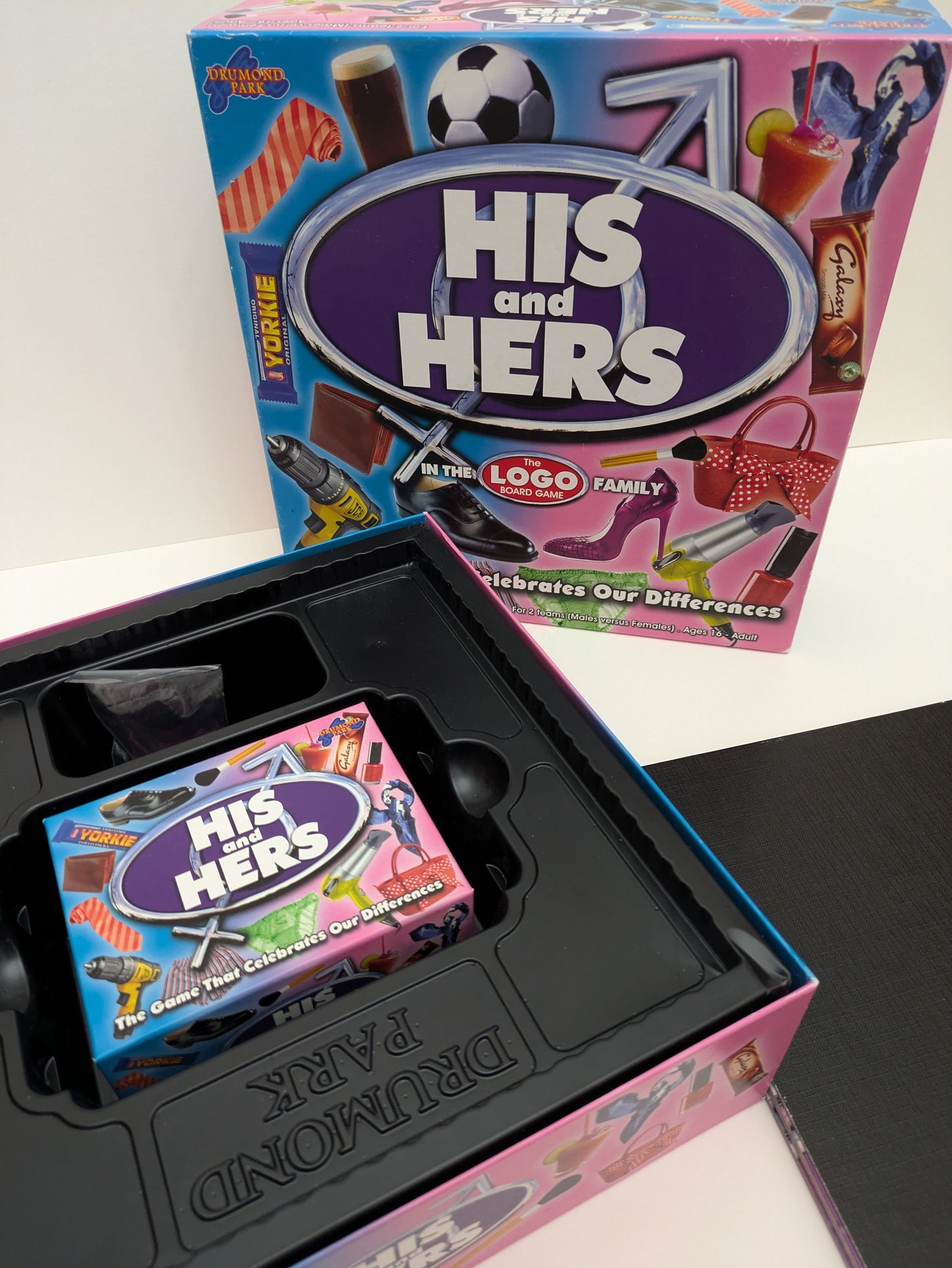 "Complete His and Hers (2011) game setup with trivia cards, game pieces, and game board ready for a fun-filled trivia night."