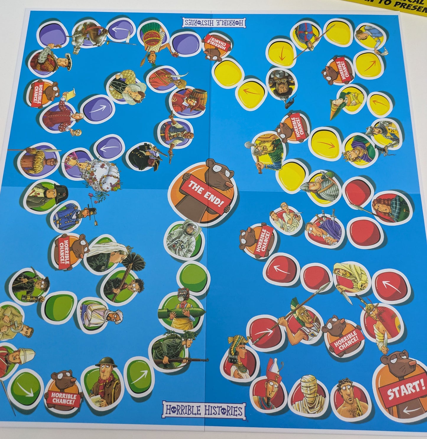 Players take turns rolling dice and answering trivia questions on Horrible Histories: The Board Game, with tokens moving along the timeline board.