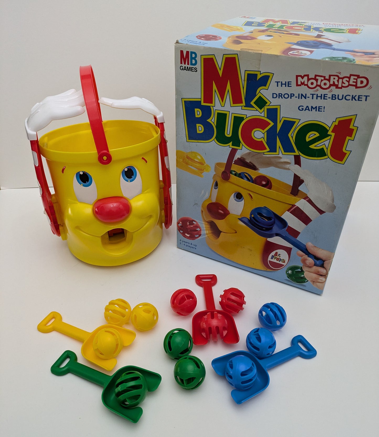 "Complete Mr. Bucket game setup with motorized bucket, colourful balls, and player shovels ready for action-packed family fun and energetic play."