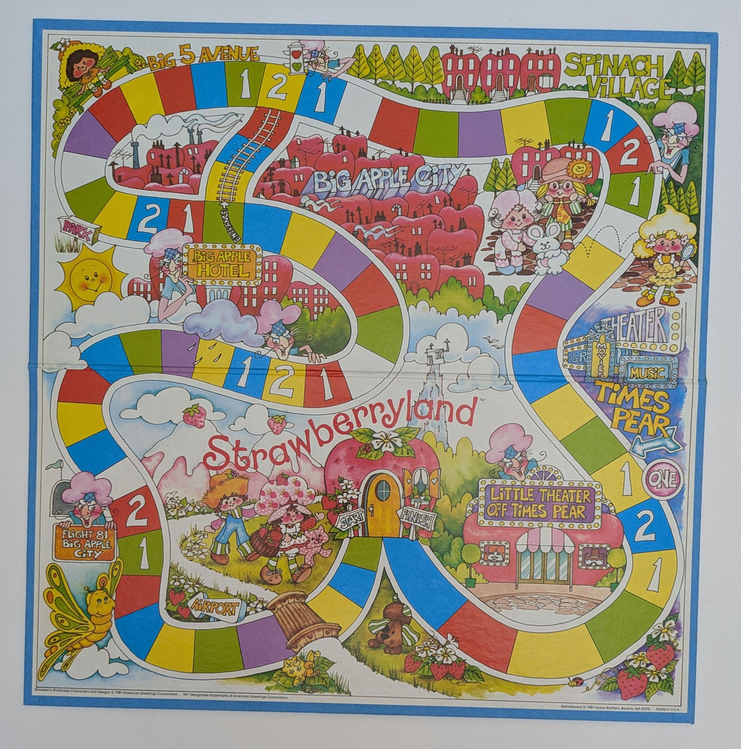 Complete setup of Strawberry Shortcake in Big Apple City with game board, character tokens, spinner, and pie cards ready for family-friendly gameplay.