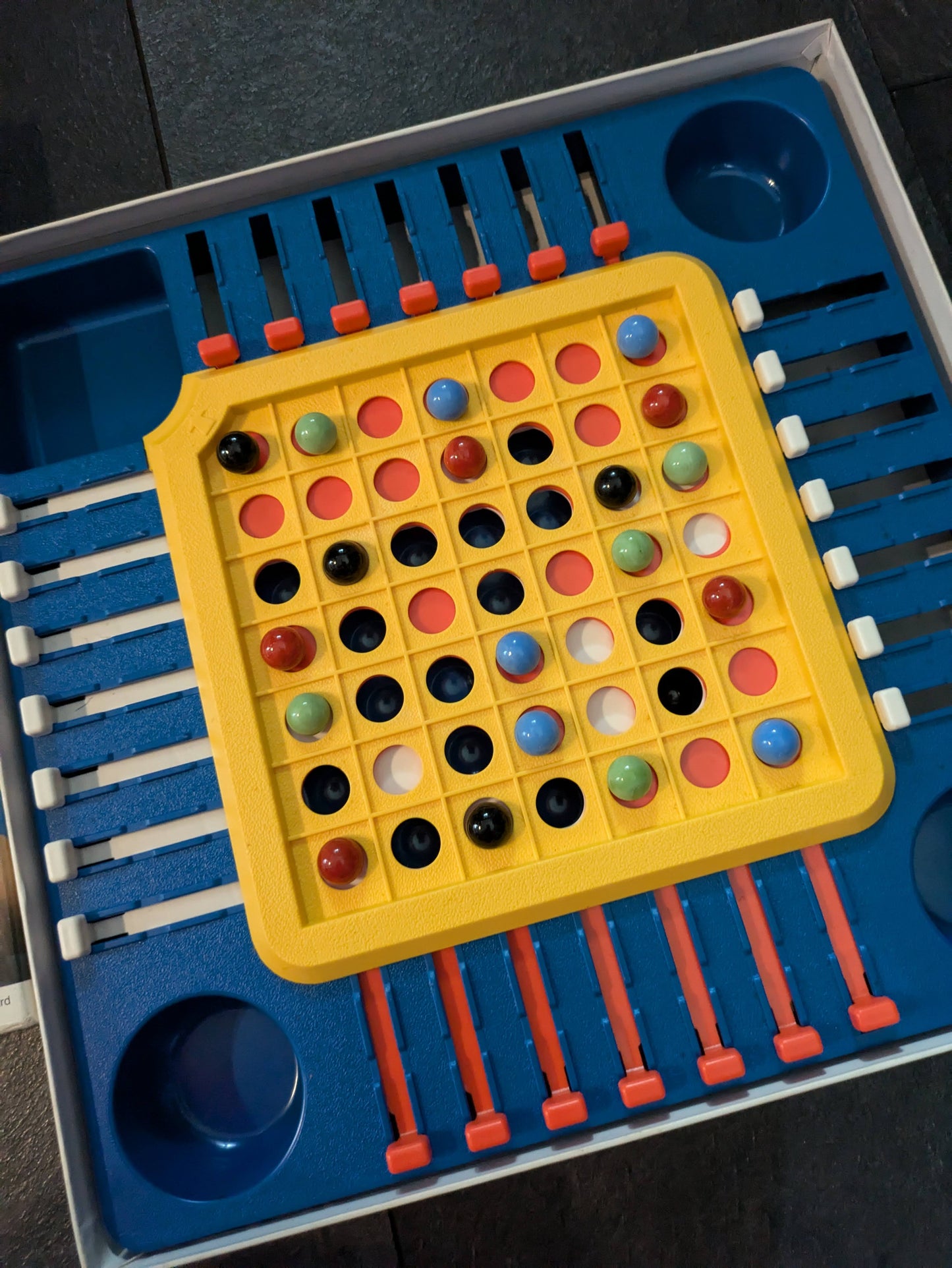 "Complete Stay Alive (1975) game setup with marbles, sliders, and board ready for action-packed, strategic fun."