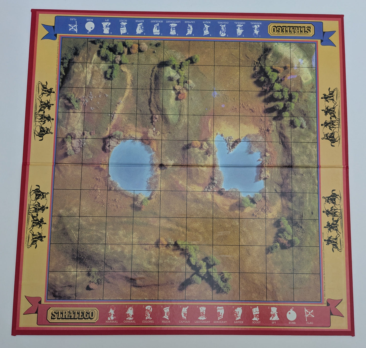 Complete Stratego (1984) game setup with game board, army pieces, and flags ready for a tactical two-player battle.