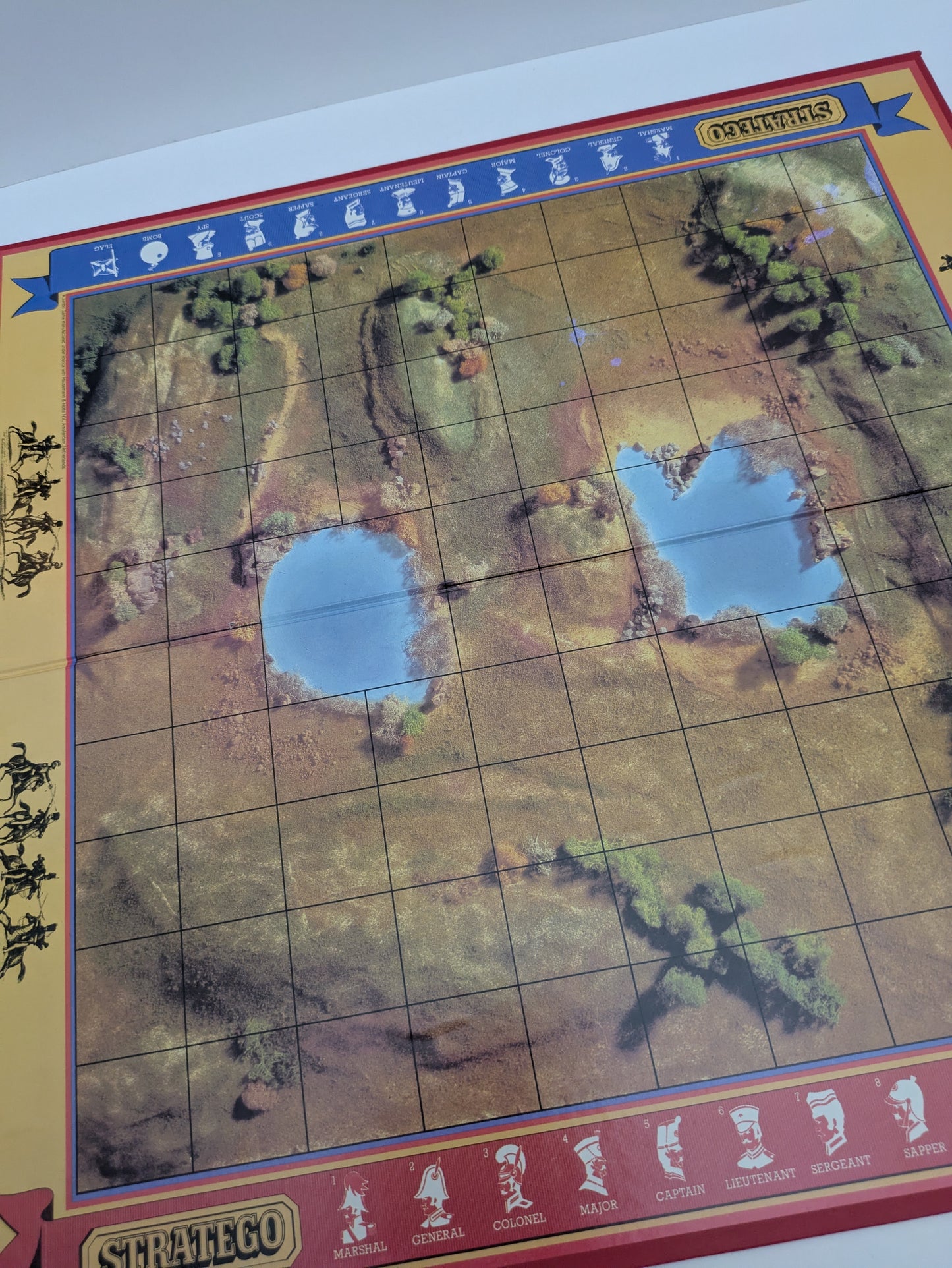 Complete Stratego (1984) game setup with game board, army pieces, and flags ready for a tactical two-player battle.