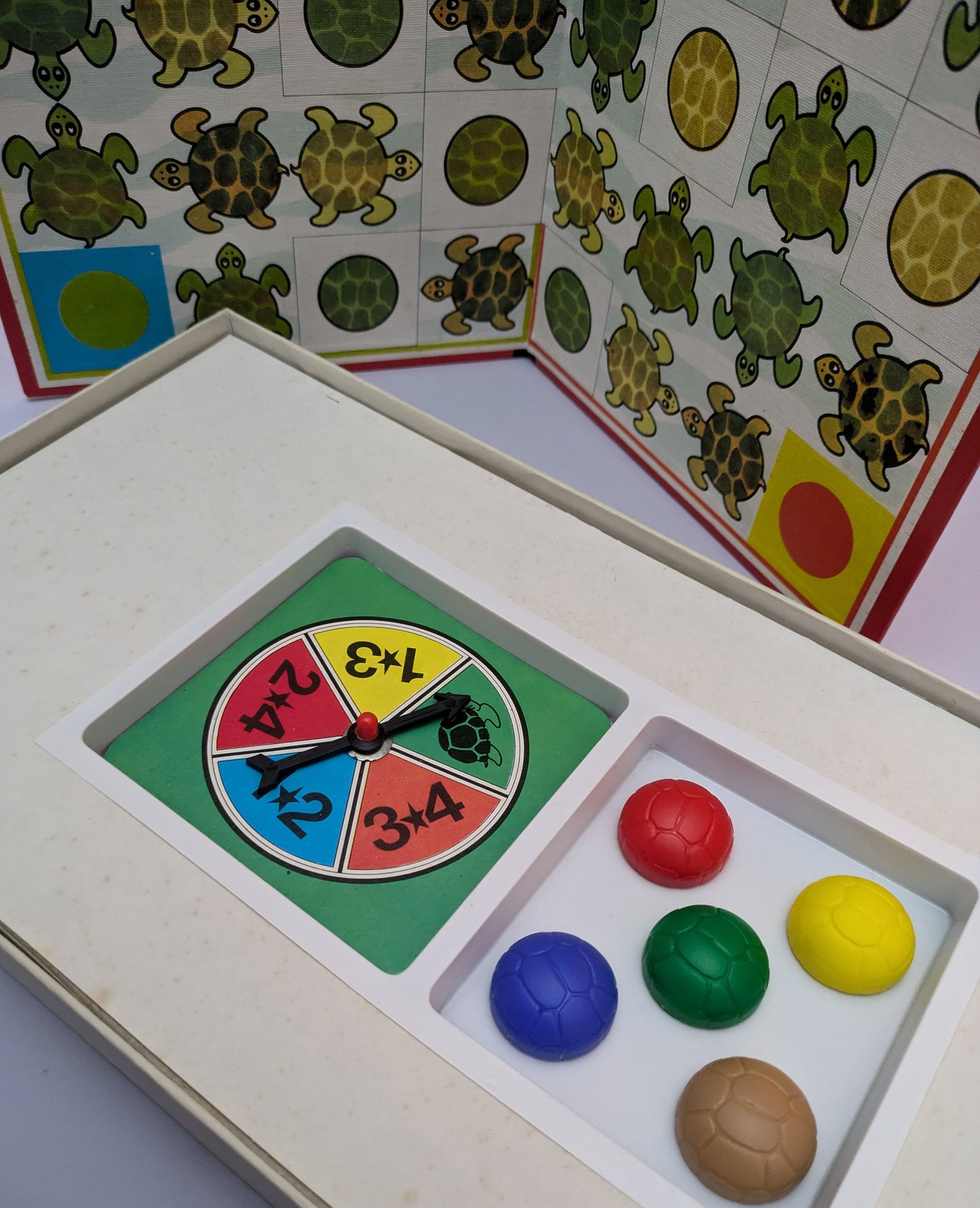 "Side view of Twisty Turtle (1982) game box featuring turtles, the game board, and racing-themed graphics emphasizing fun and competition."