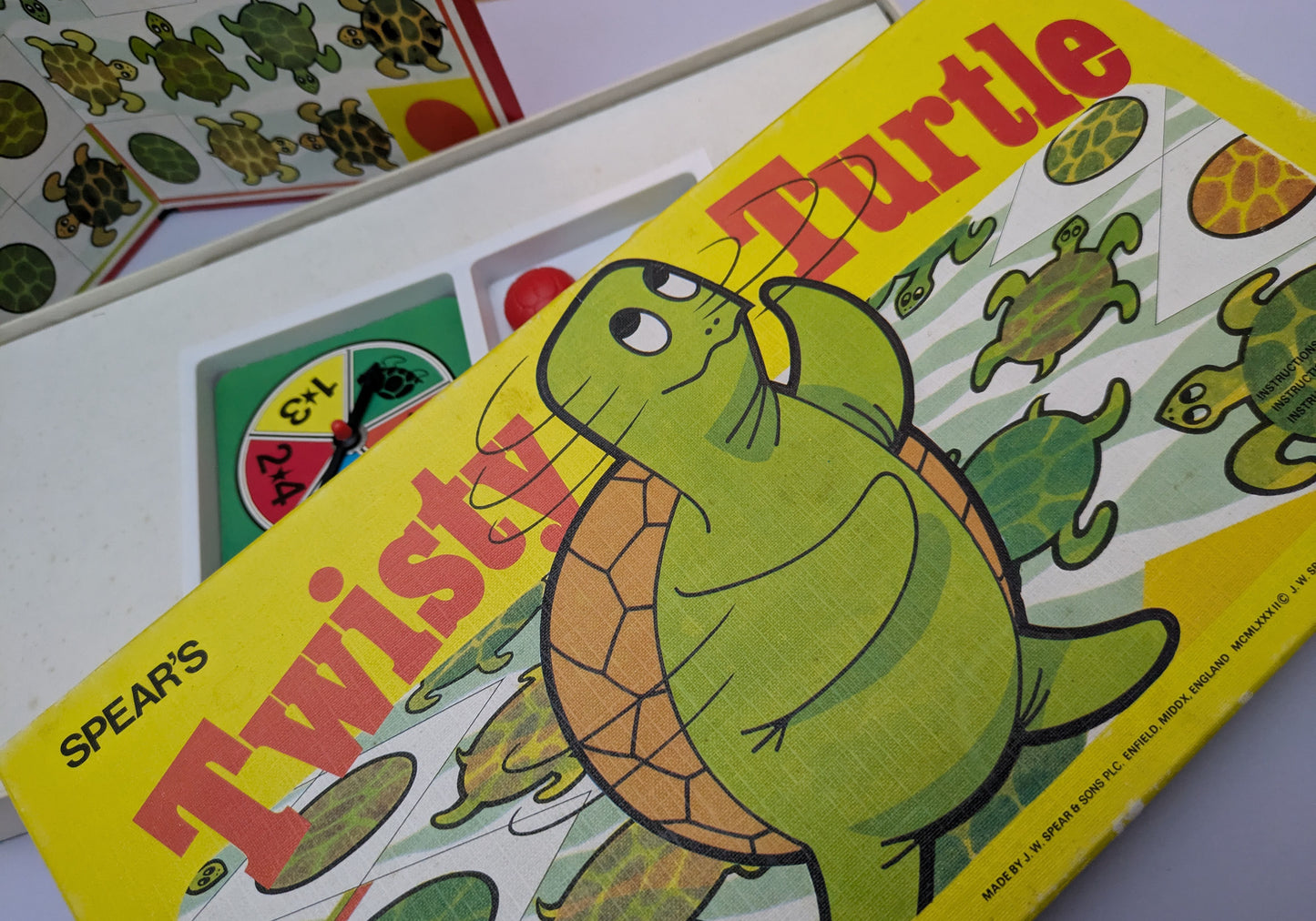 "Twisty Turtle (1982) game box featuring colourful turtles and a race-themed game board, highlighting fun and competitive gameplay."