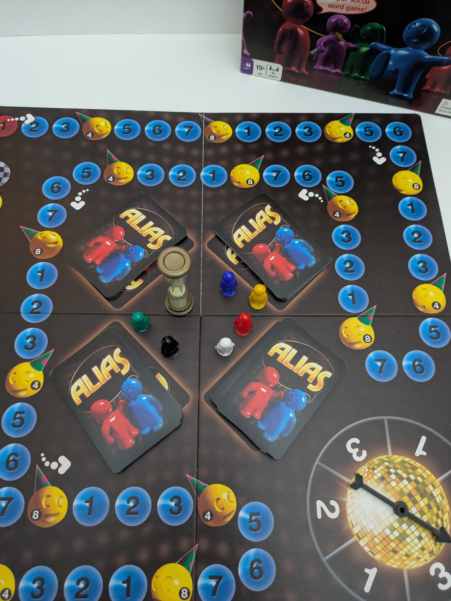 Complete Party Alias (2009) game setup with word cards, timer, and scoring pieces ready for a fun-filled word-guessing party