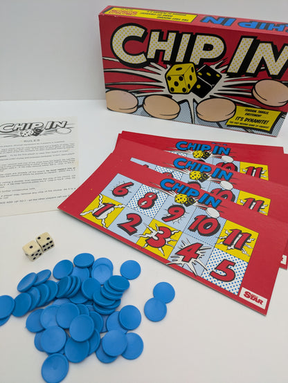 Complete Chip In (1988) setup with dice, numbered boards, and colourful chips ready for fast-paced family gameplay.