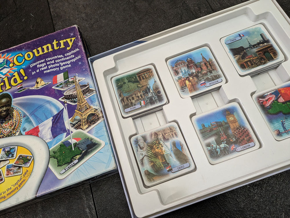 "City Country World game box featuring a colourful world map, country flags, and trivia cards emphasizing educational and interactive gameplay."
