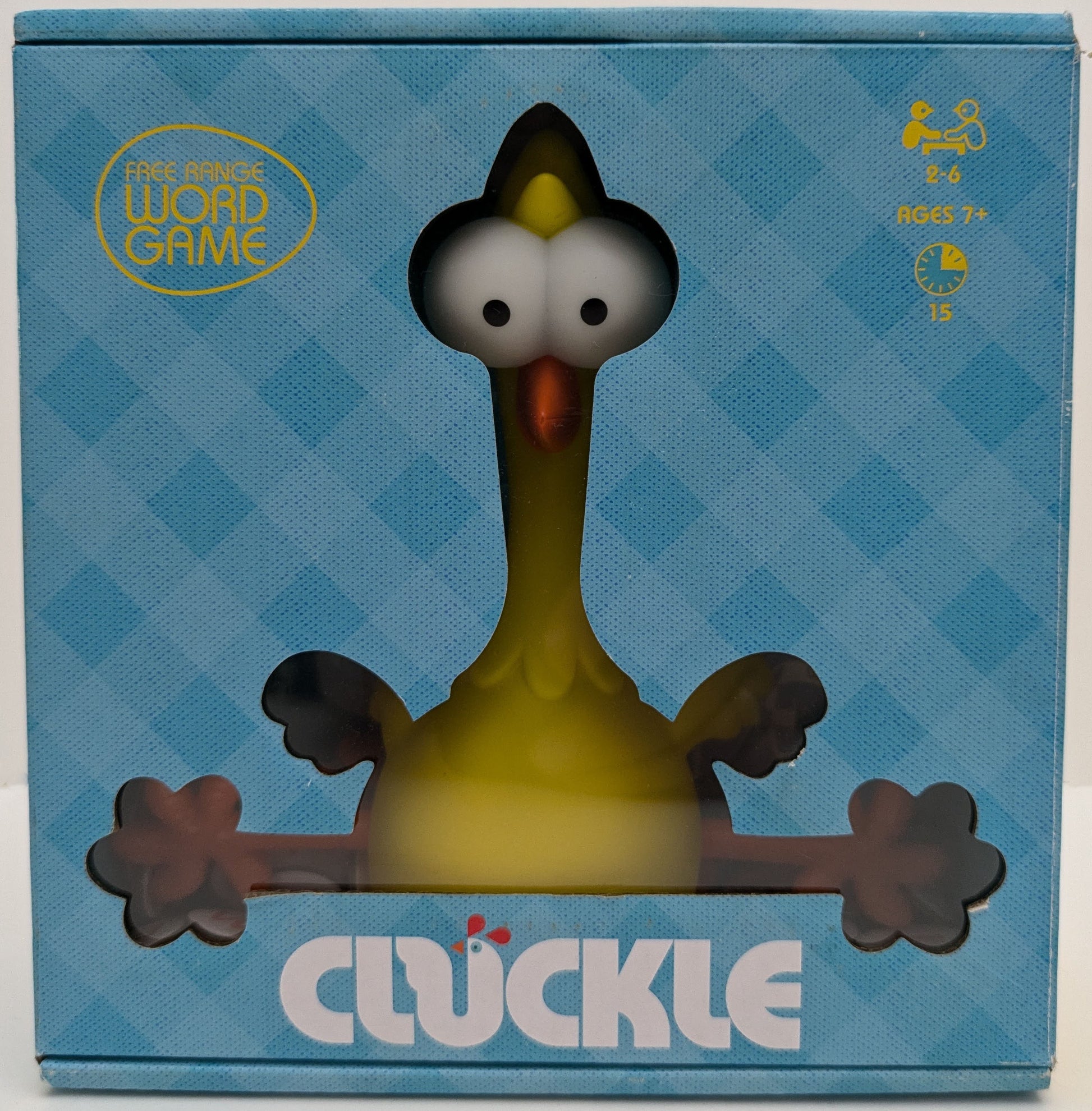 "Complete Cluckle (2021) game setup with egg tiles, rubber chicken, and scoring board ready for a fast-paced word creation race."