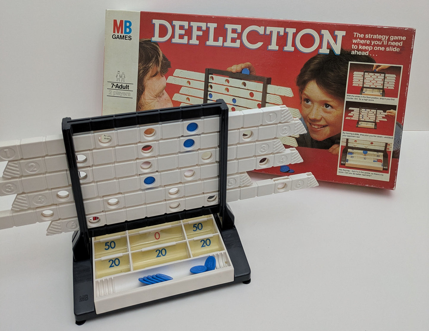 "Complete Deflection (1981) game setup with sliding rack, coloured counters, and game board ready for a competitive strategy session."
