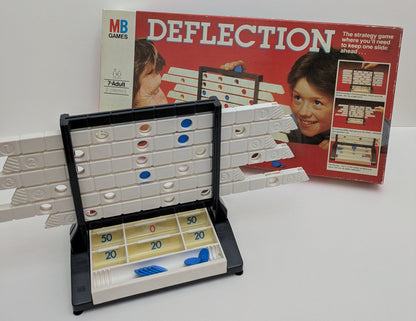 "Complete Deflection (1981) game setup with sliding rack, coloured counters, and game board ready for a competitive strategy session."