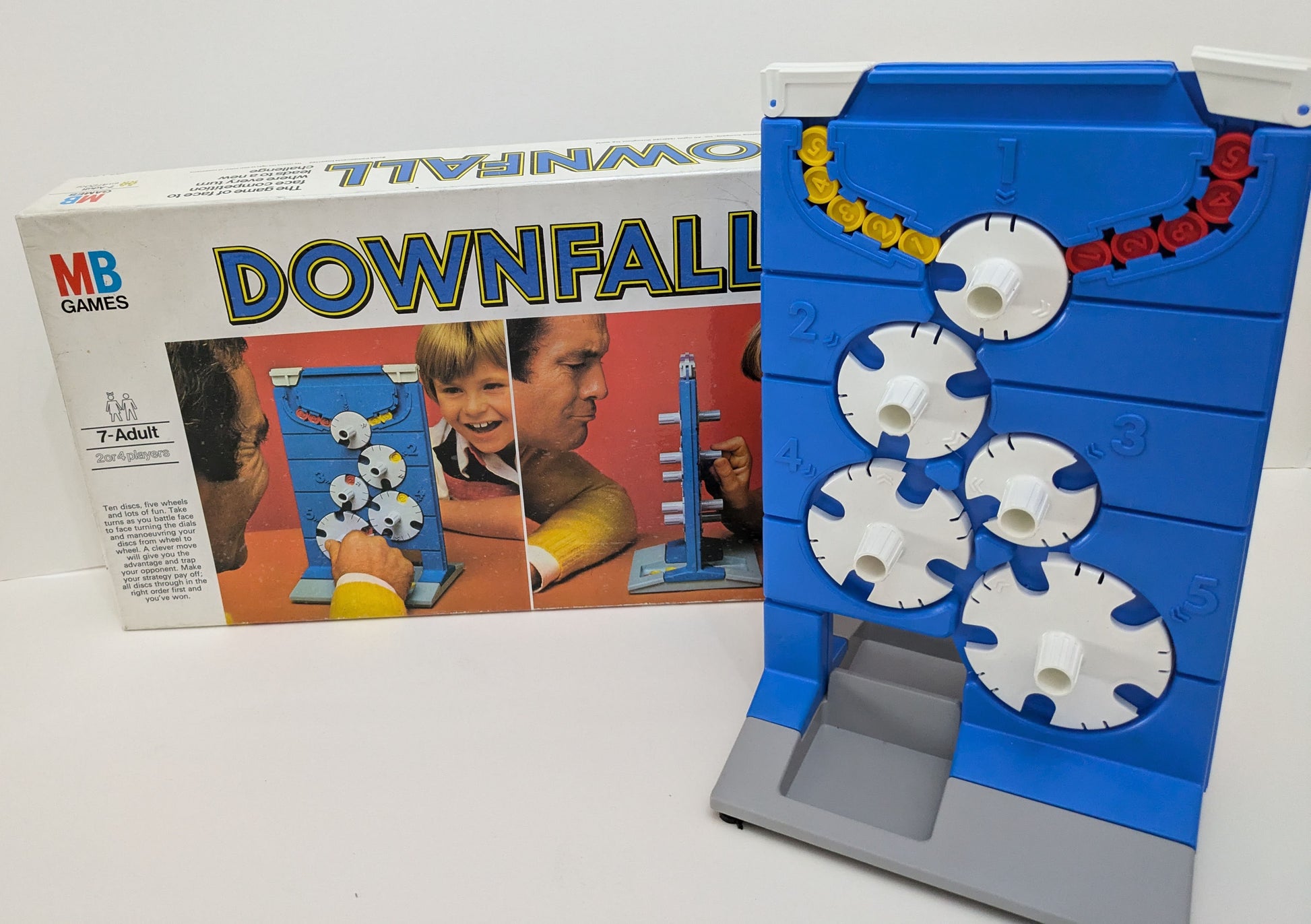 "Complete Downfall game setup featuring the game board with rotating dials and coloured discs ready for competitive play."