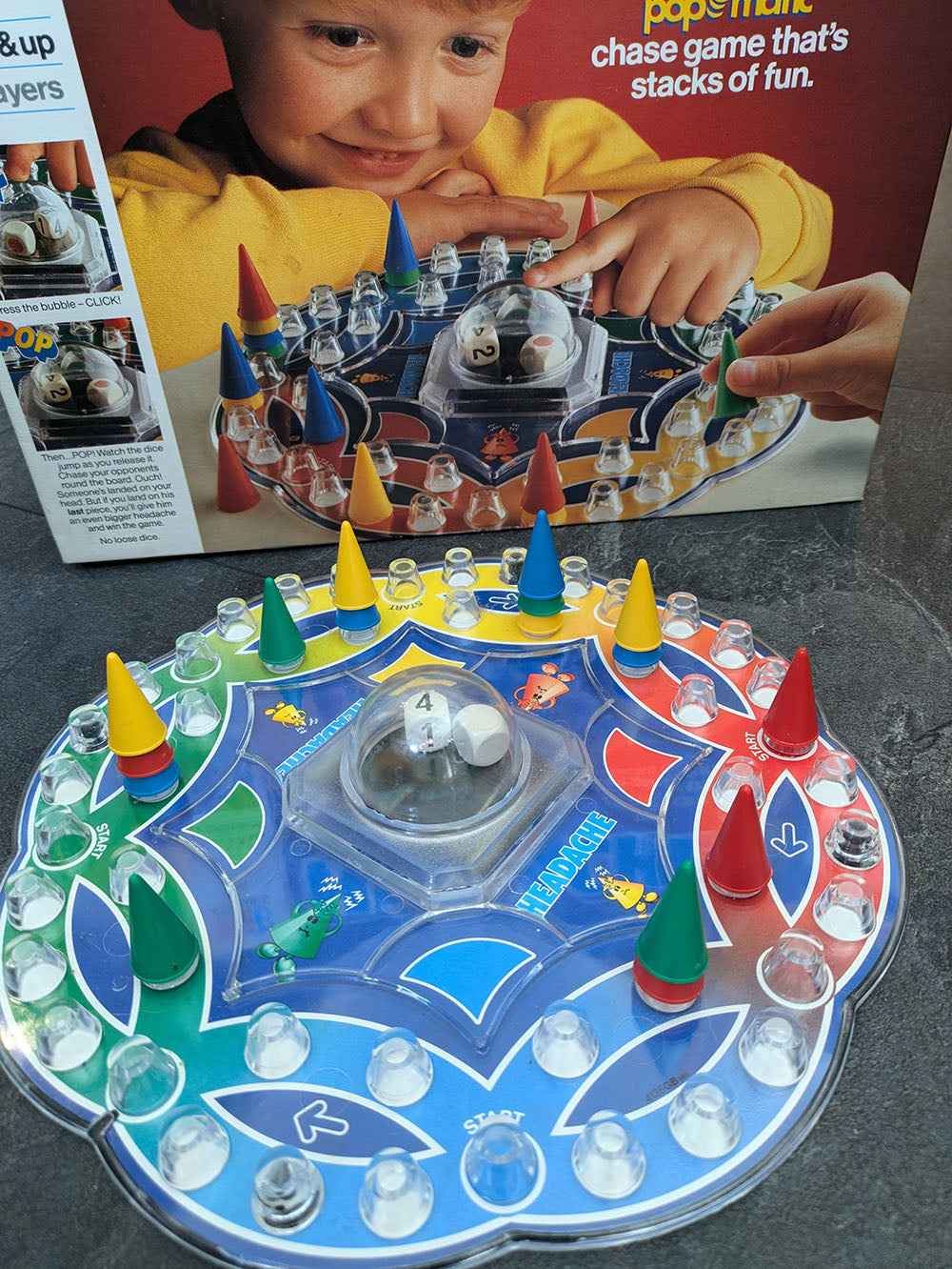 "Complete Headache game setup with game board, colourful cone pieces, and player tokens ready for strategic cone-stacking competition."