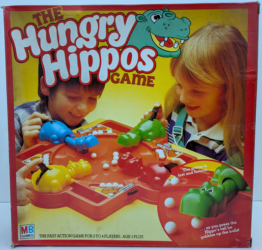 Hungry Hungry Hippos game box featuring colourful hippos, marbles, and the iconic game logo highlighting fast-paced marble-chomping fun.