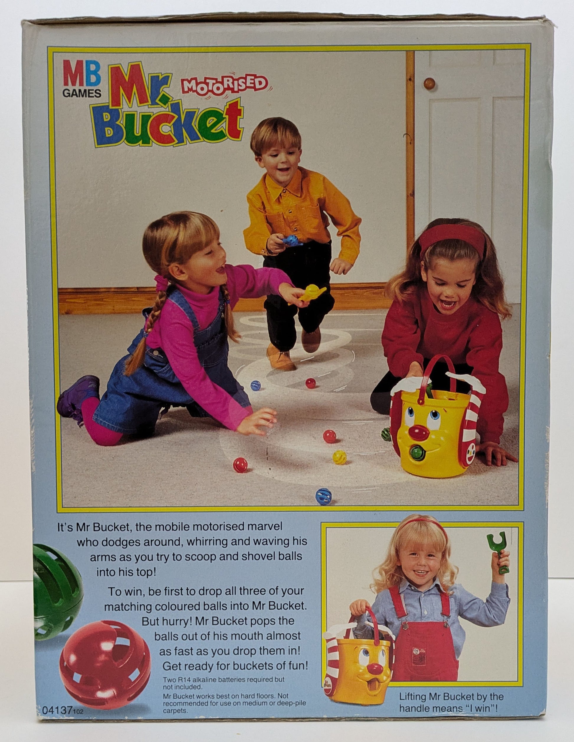 "Side view of Mr. Bucket game box showing colourful graphics of the moving bucket, balls, and shovels, emphasizing fun and fast-paced gameplay."