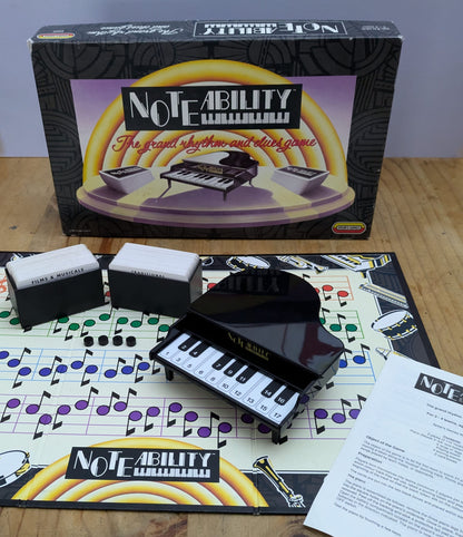 "Noteability (1990) game box featuring an electronic piano, musical notes, and song cards emphasizing fun, musical trivia gameplay."