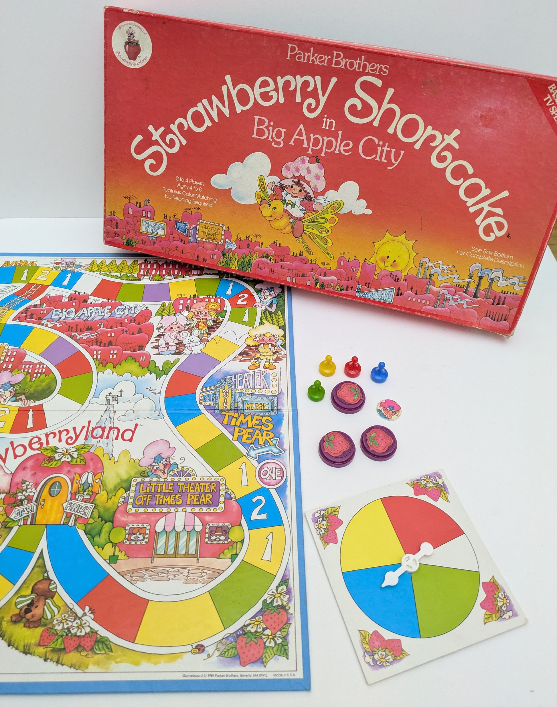 Strawberry Shortcake in Big Apple City game box featuring colourful characters, a whimsical game board, and the game logo highlighting nostalgic gameplay.