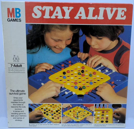 "Stay Alive (1975) game box featuring the marble survival board and sliding dials, emphasizing strategic and competitive gameplay."