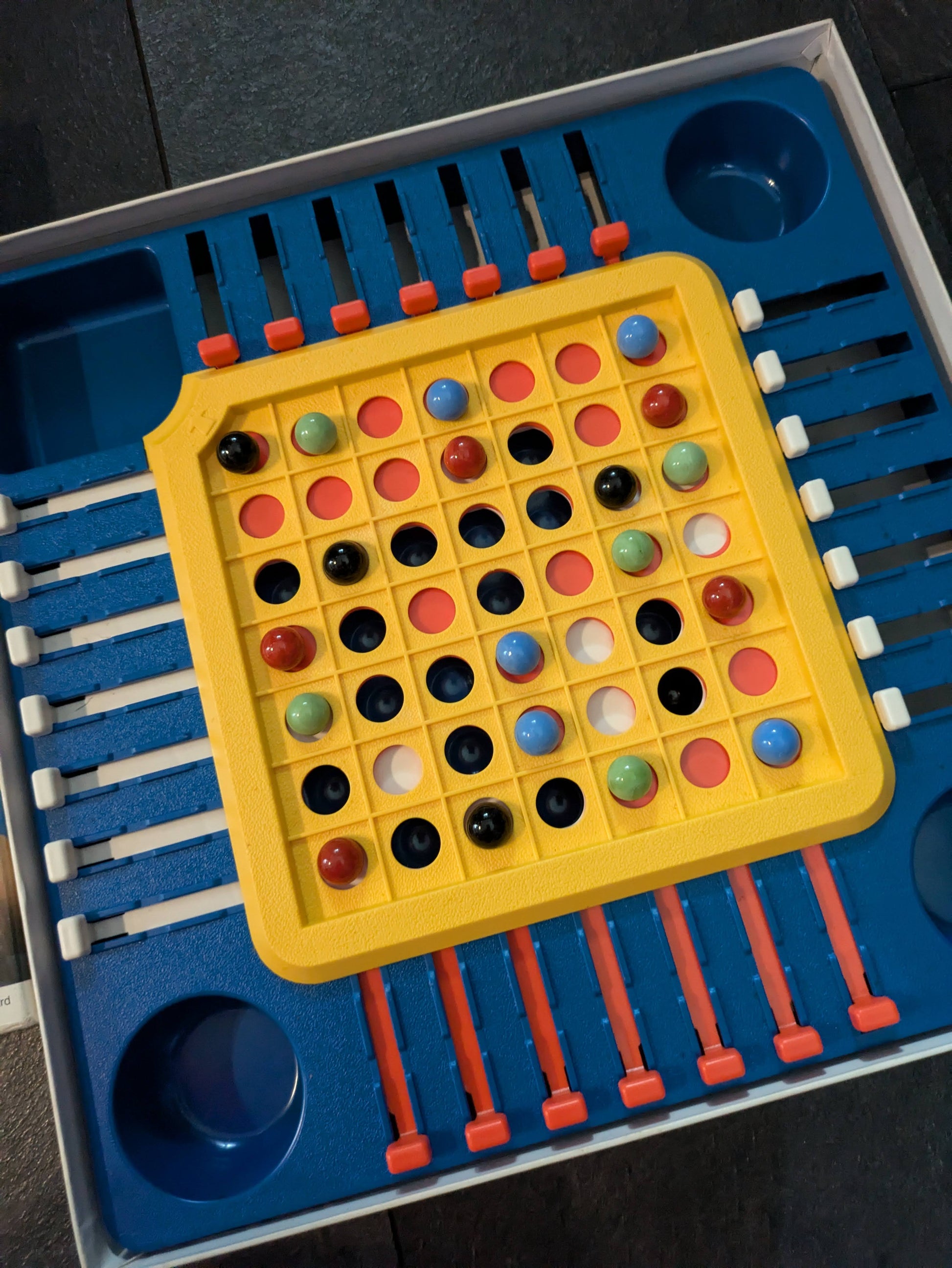 "Complete Stay Alive (1975) game setup with marbles, sliders, and board ready for action-packed, strategic fun."