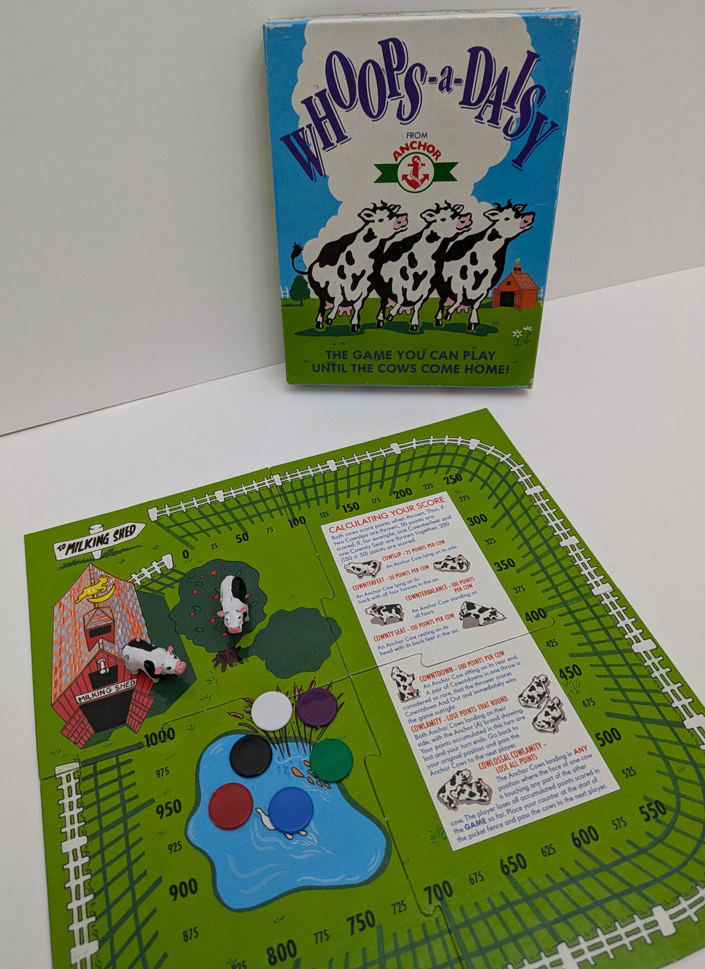 "Complete Whoops-a-Daisy (1981) game setup with farm-themed board, cow figurines, and scoring track ready for a fun cow-tossing competition."