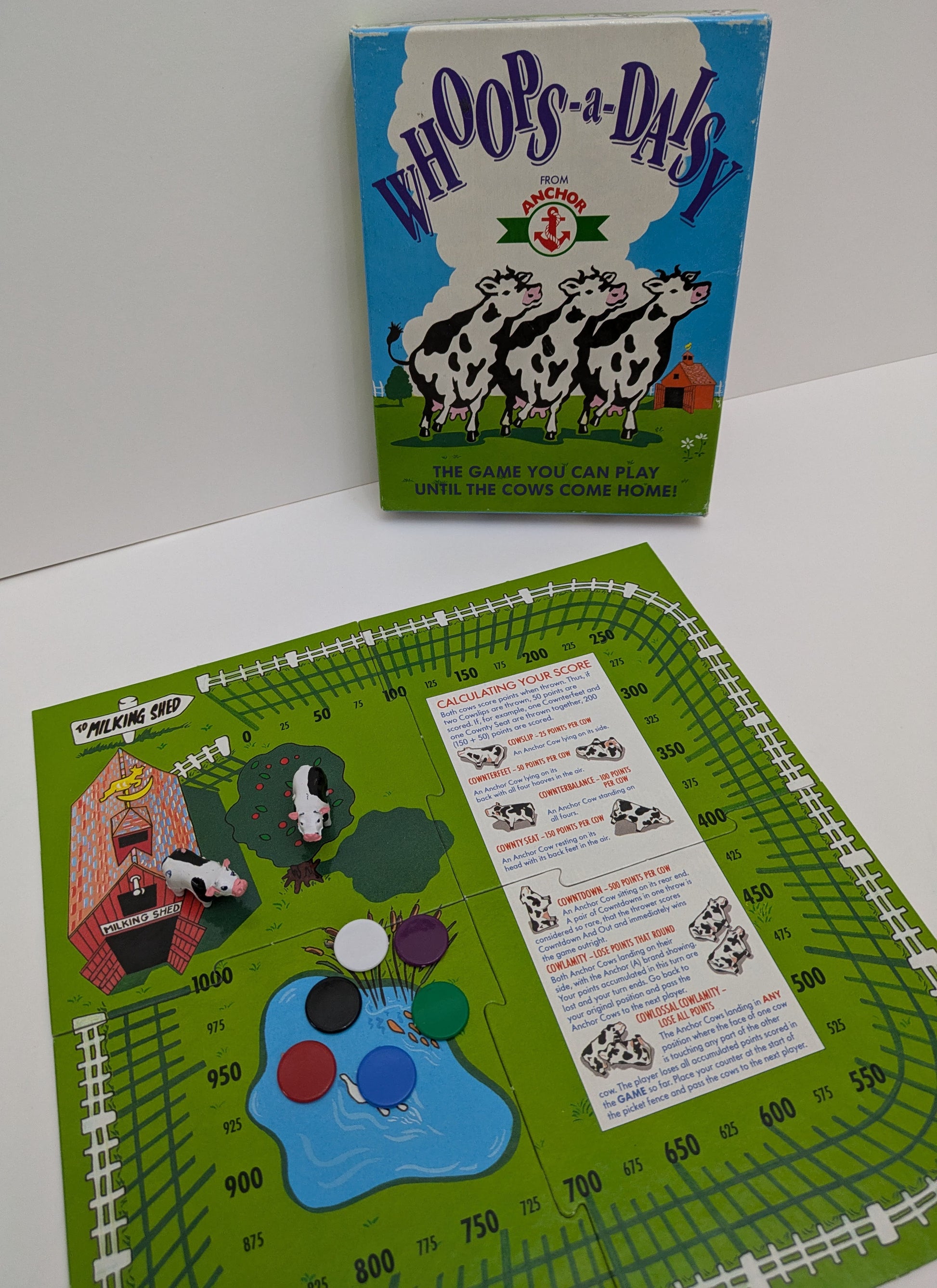 "Complete Whoops-a-Daisy (1981) game setup with farm-themed board, cow figurines, and scoring track ready for a fun cow-tossing competition."